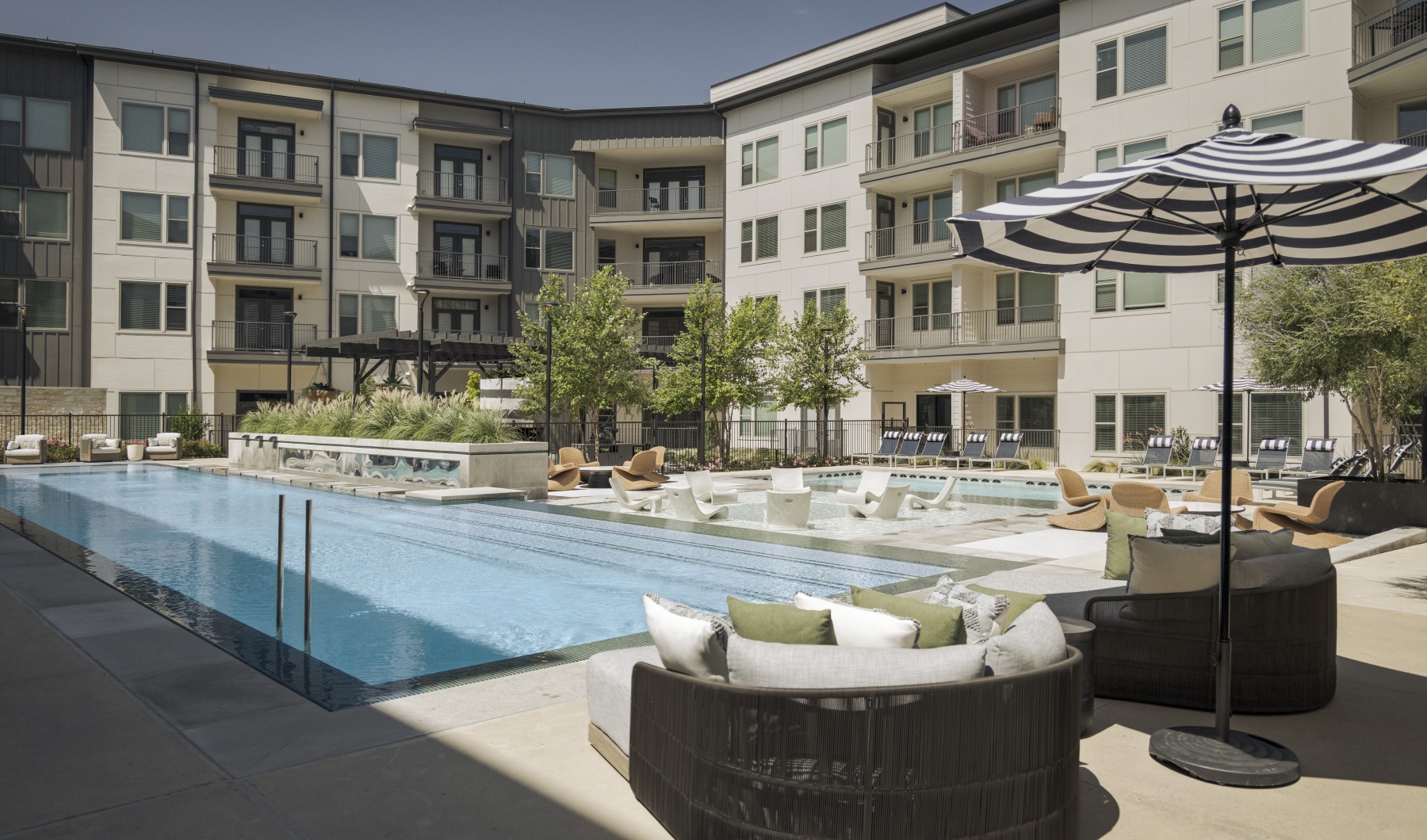 Exterior pool in courtyard with lounge chairs