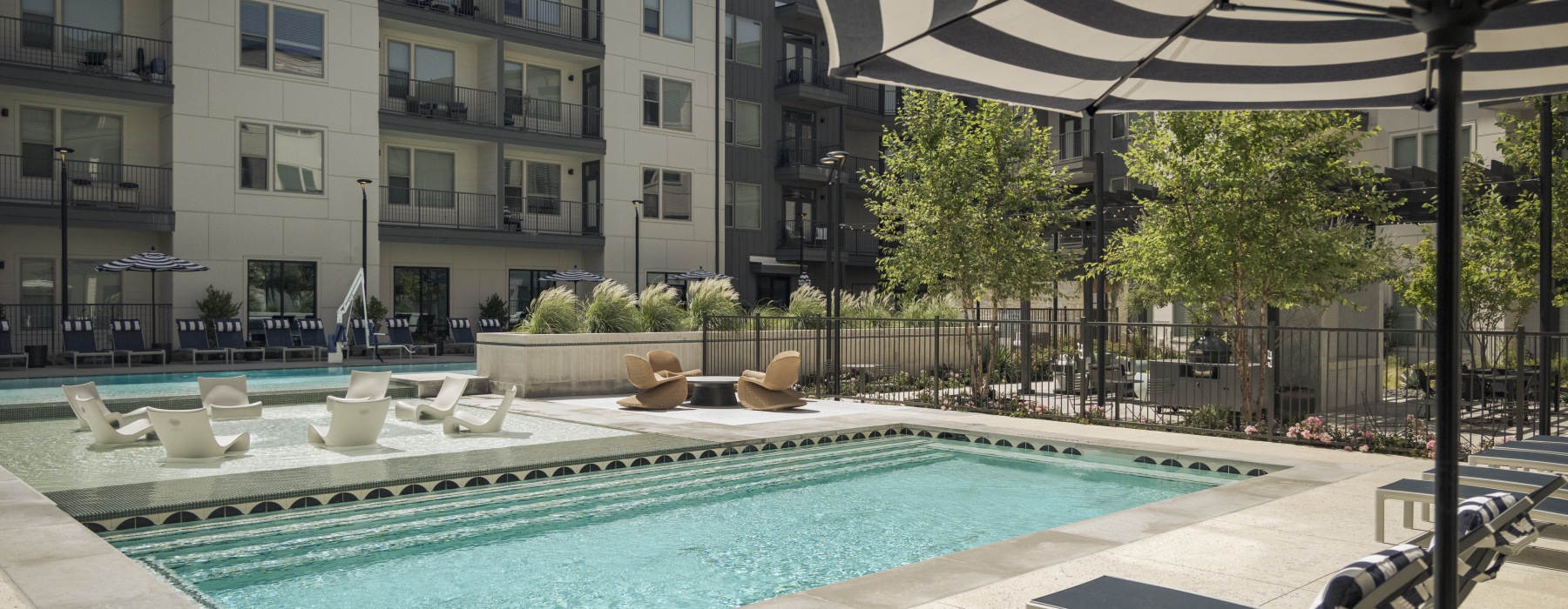 Exterior pool in courtyard with lounge chairs