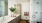 bathroom with dual sinks and backlit mirrors