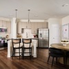 kitchen with bar stools and a table with seating