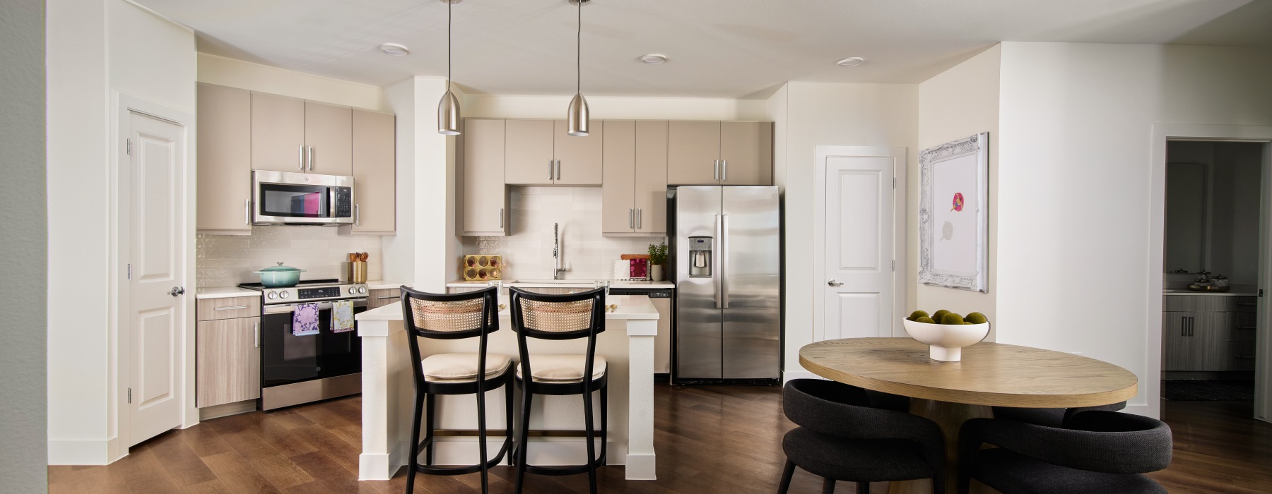 kitchen with bar stools and a table with seating