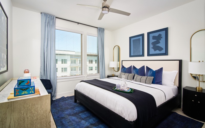 a bedroom with a bed and a fan