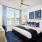 a bedroom with a bed and a fan