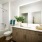 a bathroom witgh a sink and backlit mirror