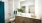 a bathroom witgh a sink and backlit mirror